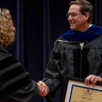 Provost Drake shaking Kevin Lehnert's hand